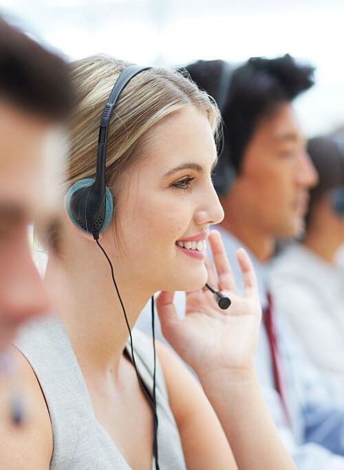 Cropped shot of telecommunications workers sitting at their desks